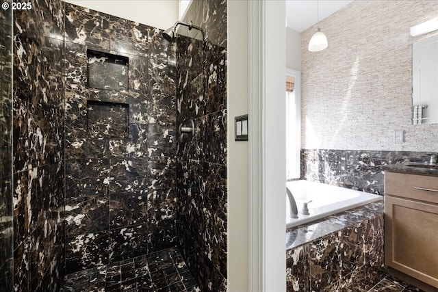 bathroom with vanity, marble finish floor, a bath, and a tile shower