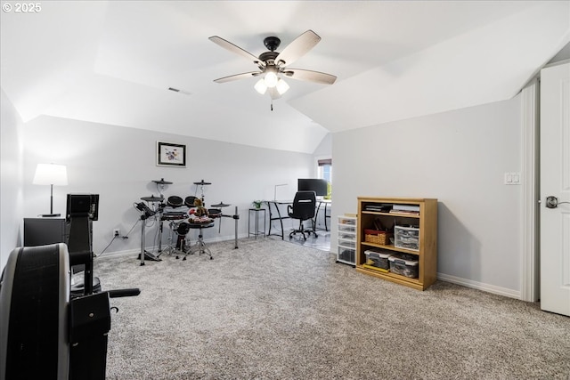interior space featuring carpet flooring, a ceiling fan, baseboards, and vaulted ceiling