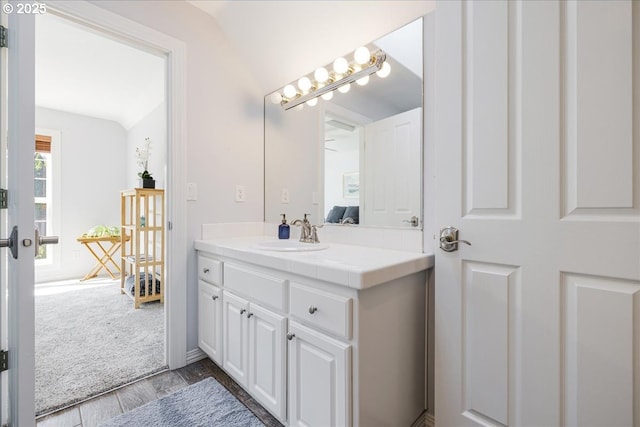 bathroom with vanity and lofted ceiling