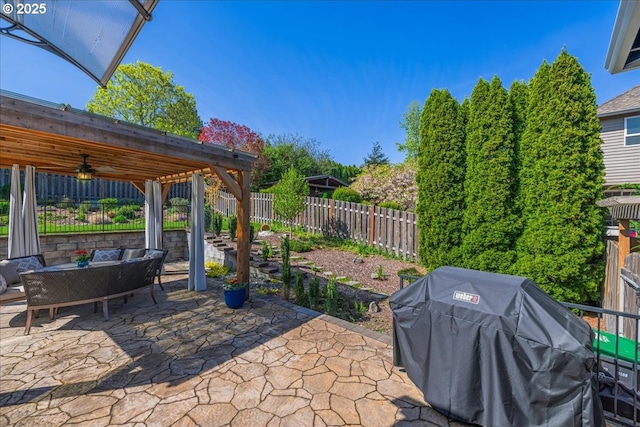 view of patio featuring a ceiling fan, outdoor dining space, a fenced backyard, and area for grilling