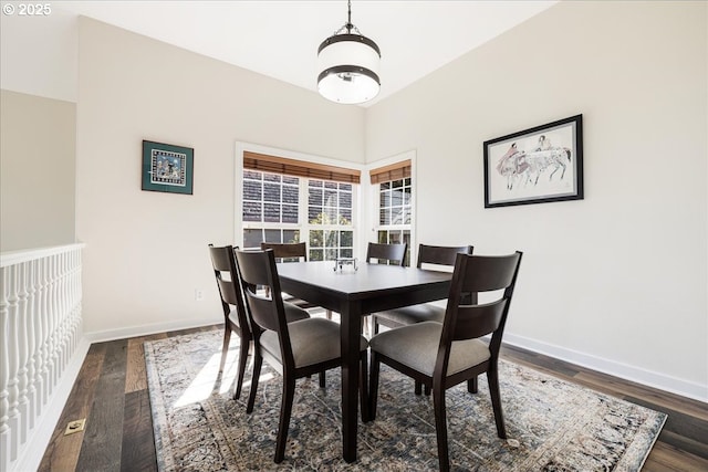 dining room with baseboards and dark wood finished floors