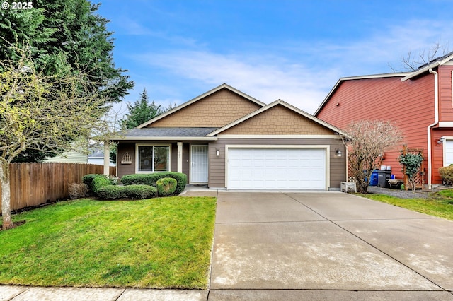 view of front of house featuring an attached garage, driveway, a front yard, and fence