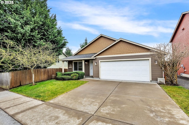 view of front of home with a garage, concrete driveway, a front yard, and fence