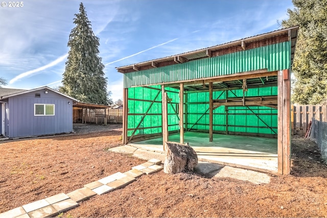 view of pole building featuring fence