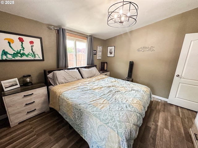1315 Auburn Ave, Baker City, OR 97814 - bedroom featuring dark wood-type flooring, a chandelier, and baseboards