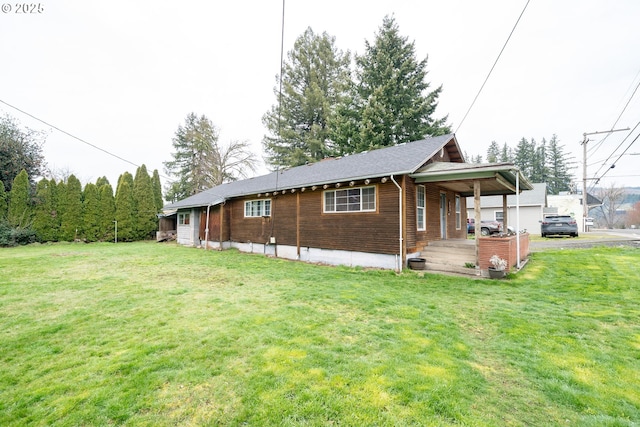 view of home's exterior with aphalt driveway, a lawn, and a carport