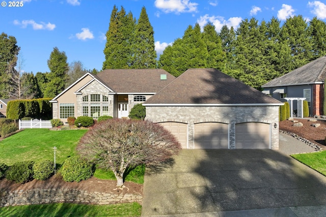 view of front of house featuring a garage and a front yard