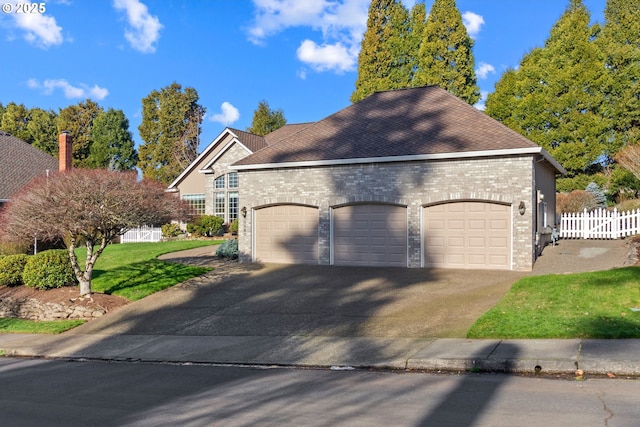 view of front of house with a front yard and a garage