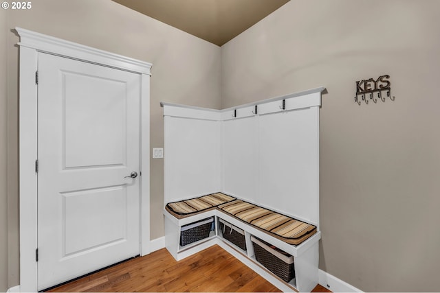 mudroom with wood finished floors and baseboards