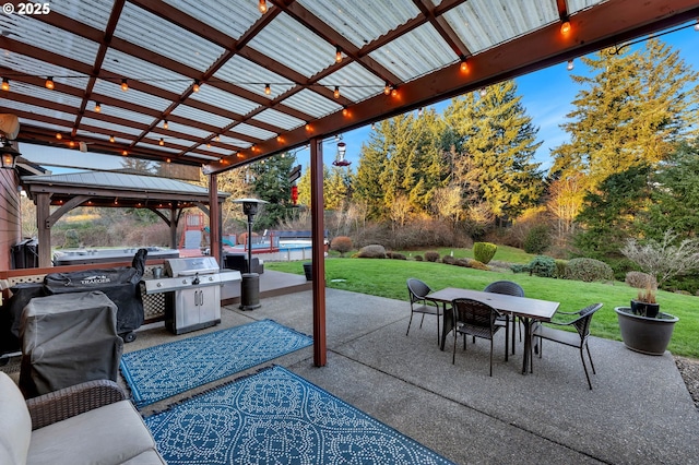 view of patio featuring a gazebo, outdoor dining space, and area for grilling