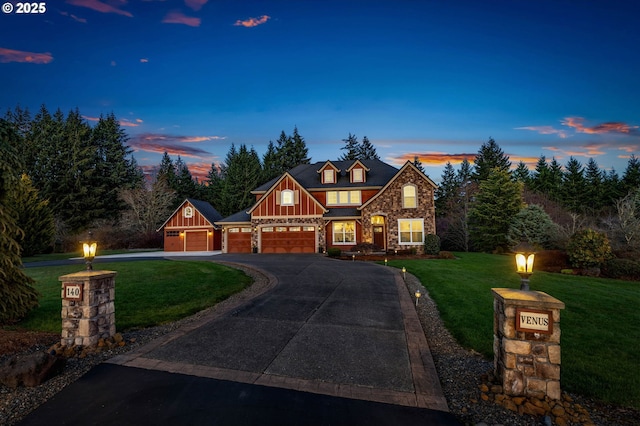 view of front of house with an attached garage, board and batten siding, a front yard, stone siding, and driveway