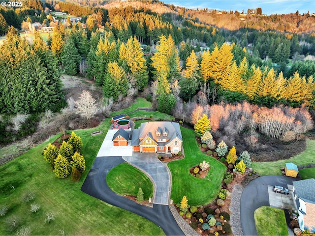 birds eye view of property featuring a wooded view