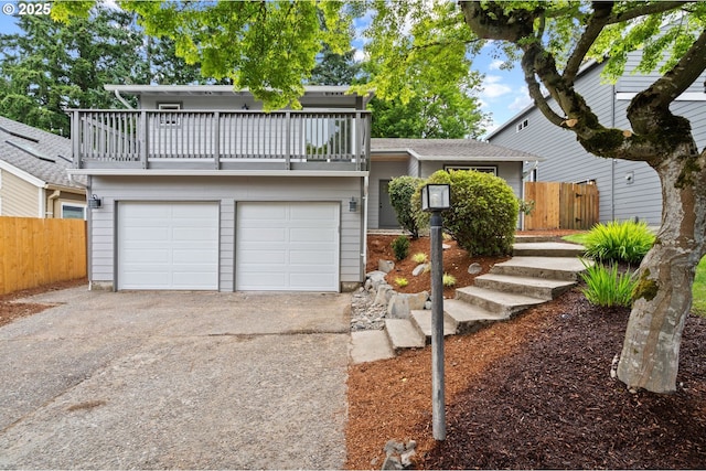 6300 SW Arranmore Pl, Portland, OR 97223 - view of front of property with a balcony, concrete driveway, and a garage