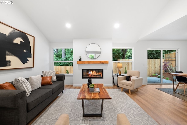 6300 SW Arranmore Pl, Portland, OR 97223 - living area with vaulted ceiling, wood finished floors, a glass covered fireplace, and recessed lighting