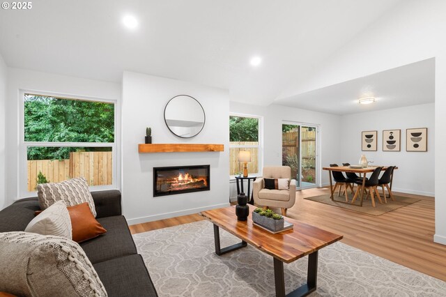 6300 SW Arranmore Pl, Portland, OR 97223 - living area with a glass covered fireplace, lofted ceiling, wood finished floors, and recessed lighting