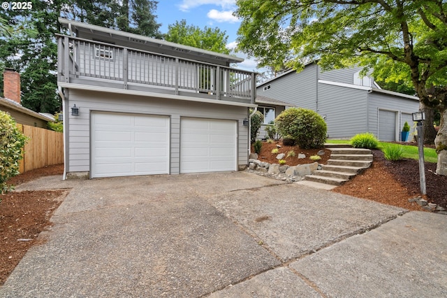 6300 SW Arranmore Pl, Portland, OR 97223 - view of front facade with a balcony, an attached garage, and driveway