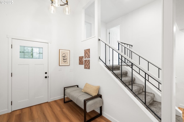 6300 SW Arranmore Pl, Portland, OR 97223 - foyer featuring wood finished floors, stairs, a chandelier, and a towering ceiling