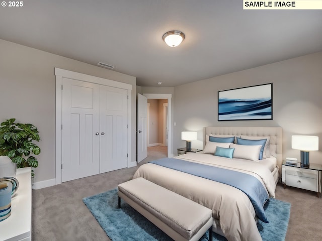 carpeted bedroom with baseboards and a closet