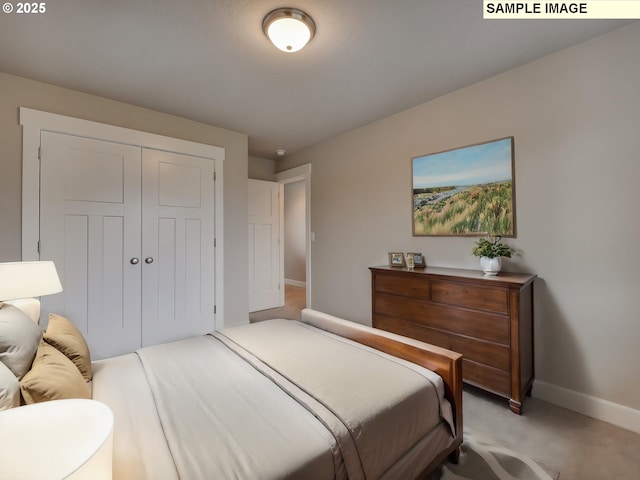 bedroom featuring baseboards, light colored carpet, and a closet