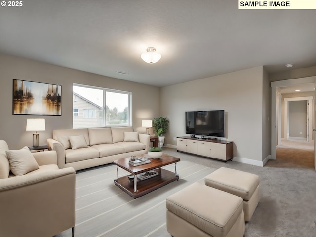 carpeted living area with baseboards