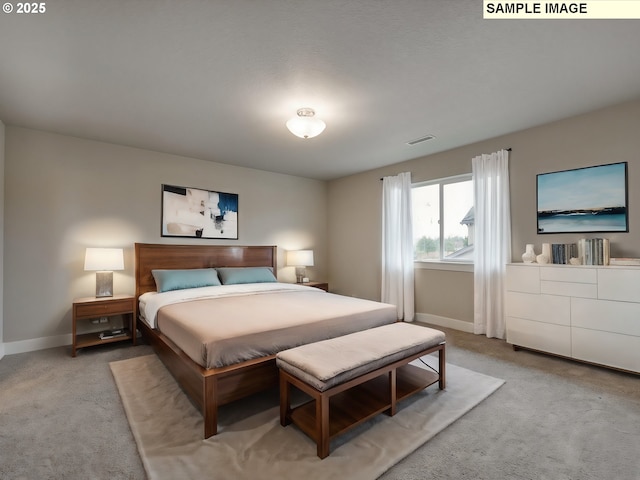 bedroom with light colored carpet and baseboards