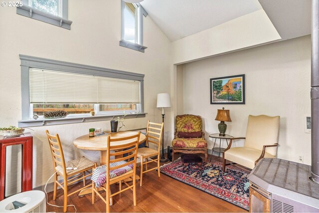 dining space with high vaulted ceiling, wood finished floors, and a healthy amount of sunlight
