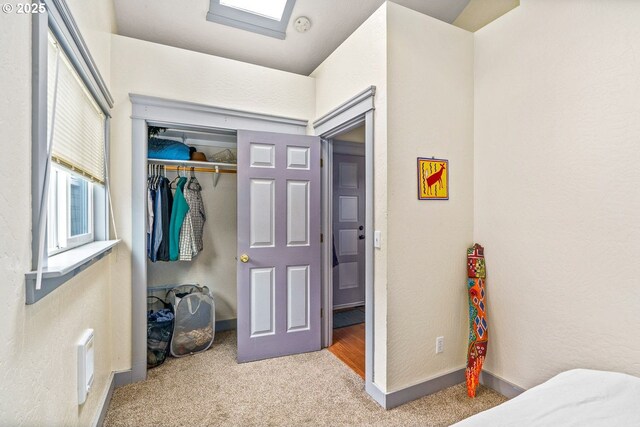bedroom featuring baseboards, visible vents, a closet, and carpet
