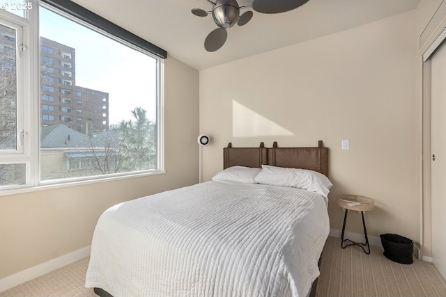 bedroom with light carpet and ceiling fan