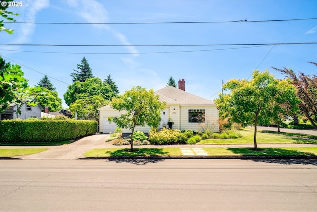 3556 NE Alberta Ct, Portland, OR 97211 - obstructed view of property with concrete driveway, a front lawn, and an attached garage