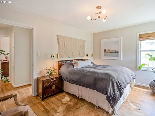 3556 NE Alberta Ct, Portland, OR 97211 - bedroom with light wood-style flooring, a chandelier, and baseboards