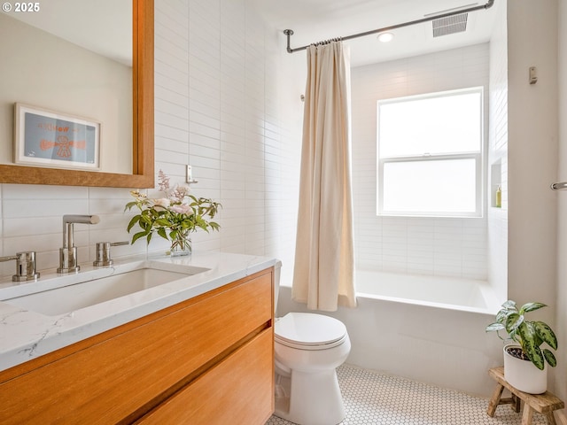 3556 NE Alberta Ct, Portland, OR 97211 - full bath featuring vanity, toilet, shower / bathtub combination with curtain, backsplash, and tile walls