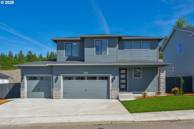 143 W 20th Way, La Center, WA 98629 - prairie-style house with stone siding, concrete driveway, and a garage