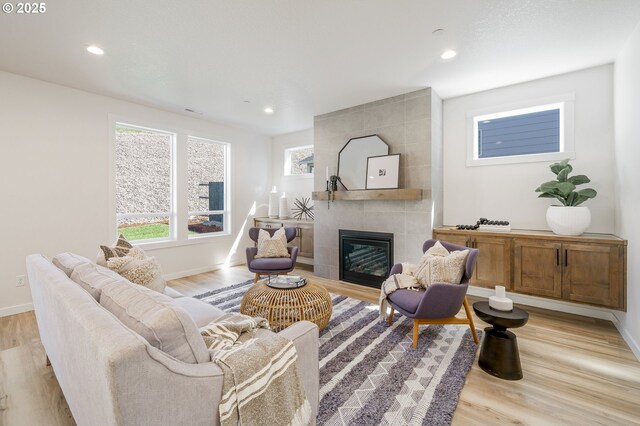 143 W 20th Way, La Center, WA 98629 - living room with light wood-style flooring, a tile fireplace, and recessed lighting