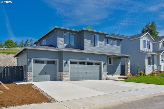 143 W 20th Way, La Center, WA 98629 - view of front facade with driveway, stone siding, and an attached garage