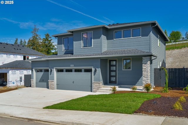143 W 20th Way, La Center, WA 98629 - prairie-style house with stone siding, driveway, and a garage
