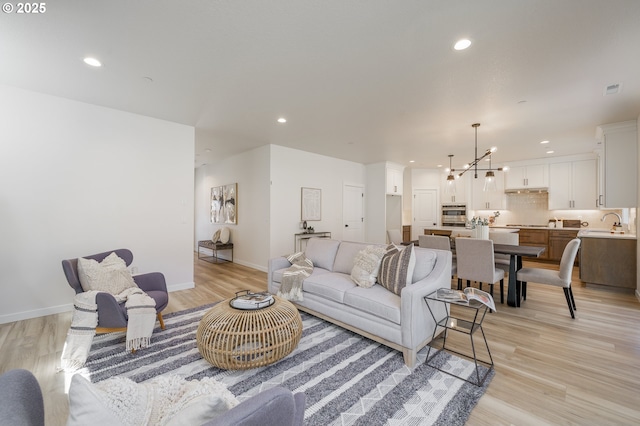143 W 20th Way, La Center, WA 98629 - living area featuring light wood-style floors, a chandelier, and recessed lighting