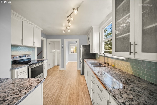 kitchen featuring sink, stone countertops, electric range, light hardwood / wood-style floors, and white cabinets