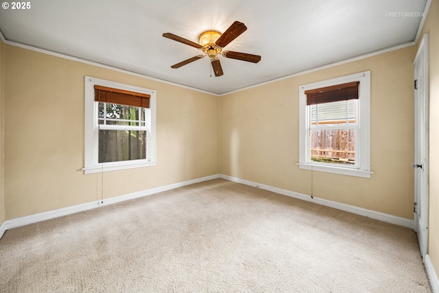 empty room featuring crown molding, carpet floors, and ceiling fan