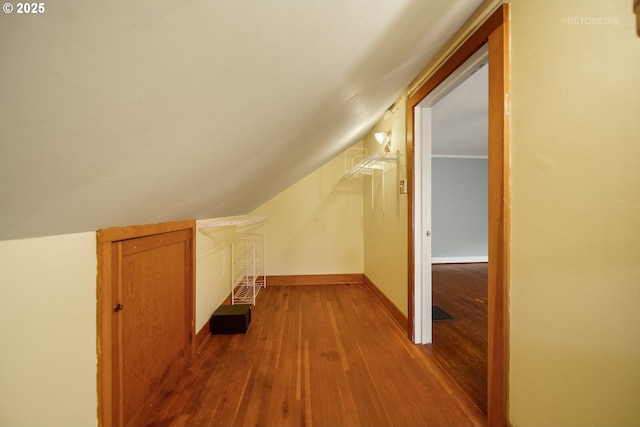 bonus room featuring vaulted ceiling and light wood-type flooring