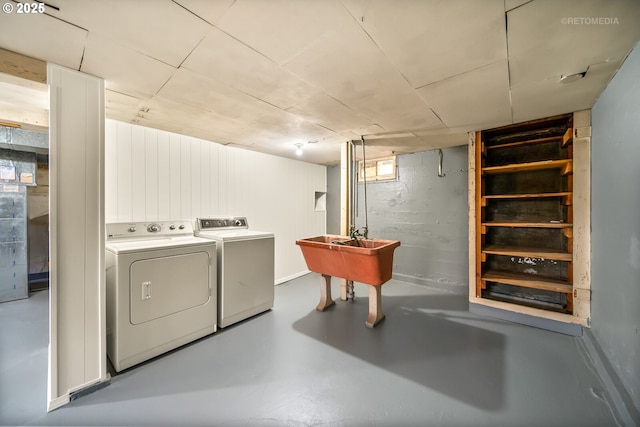 clothes washing area with sink and independent washer and dryer