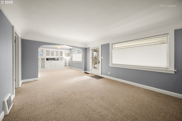 unfurnished living room with light colored carpet