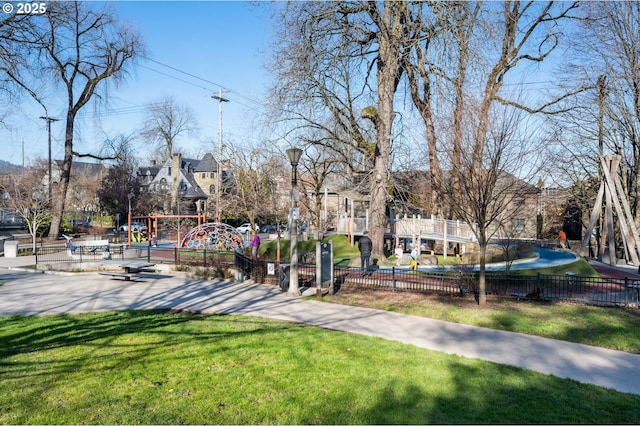 view of home's community featuring a playground and a lawn