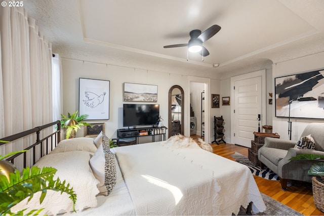 bedroom featuring wood-type flooring and washer / clothes dryer