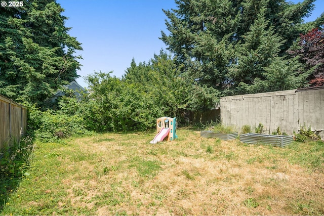 9465 N Midway Ave, Portland, OR 97203 - fenced backyard featuring a vegetable garden