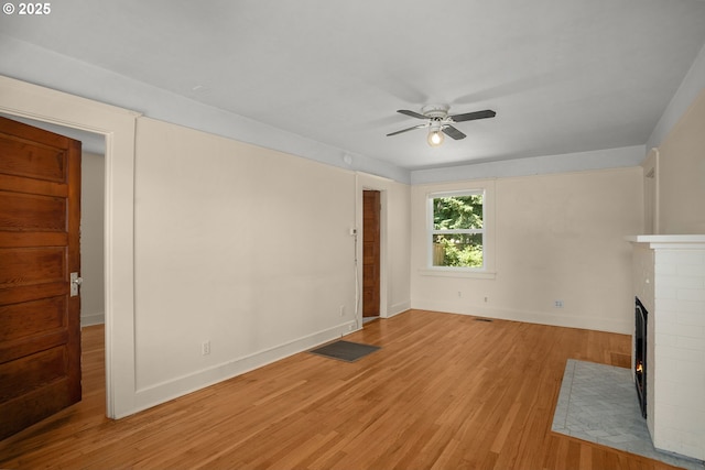 9465 N Midway Ave, Portland, OR 97203 - unfurnished living room with a ceiling fan, light wood-style flooring, and a fireplace