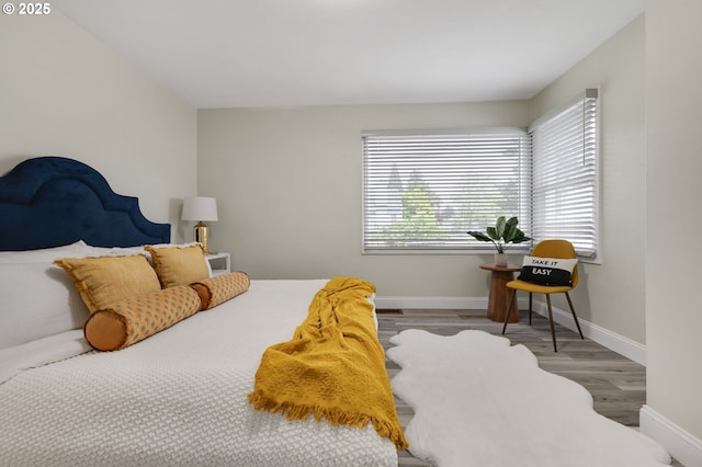 bedroom with wood finished floors and baseboards
