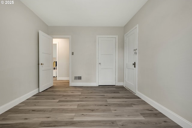 unfurnished bedroom featuring light wood-style flooring and baseboards