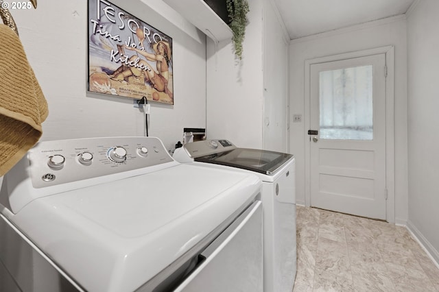 laundry area featuring washer and dryer, baseboards, and ornamental molding