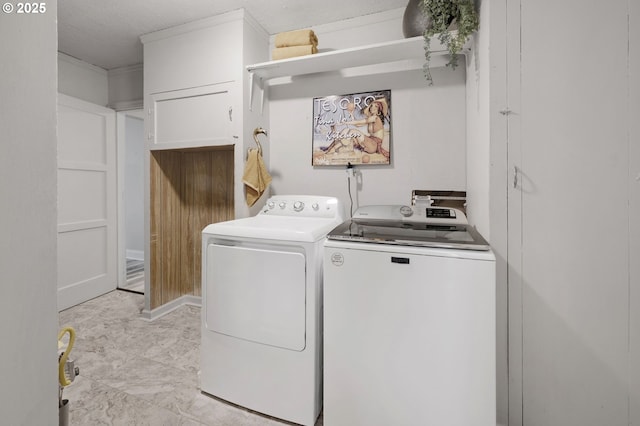 clothes washing area with washing machine and dryer