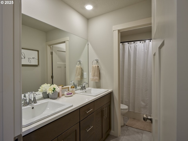 2614 S 7th Way, Ridgefield, WA 98642 - bathroom featuring toilet, double vanity, tile patterned flooring, and a shower with shower curtain